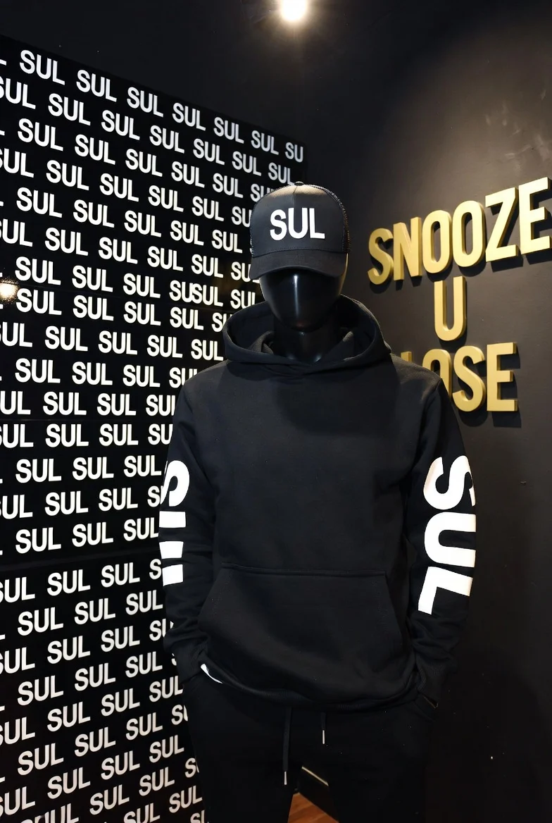 Blackout Hoodie and SUL cap styled on a store mannequin
